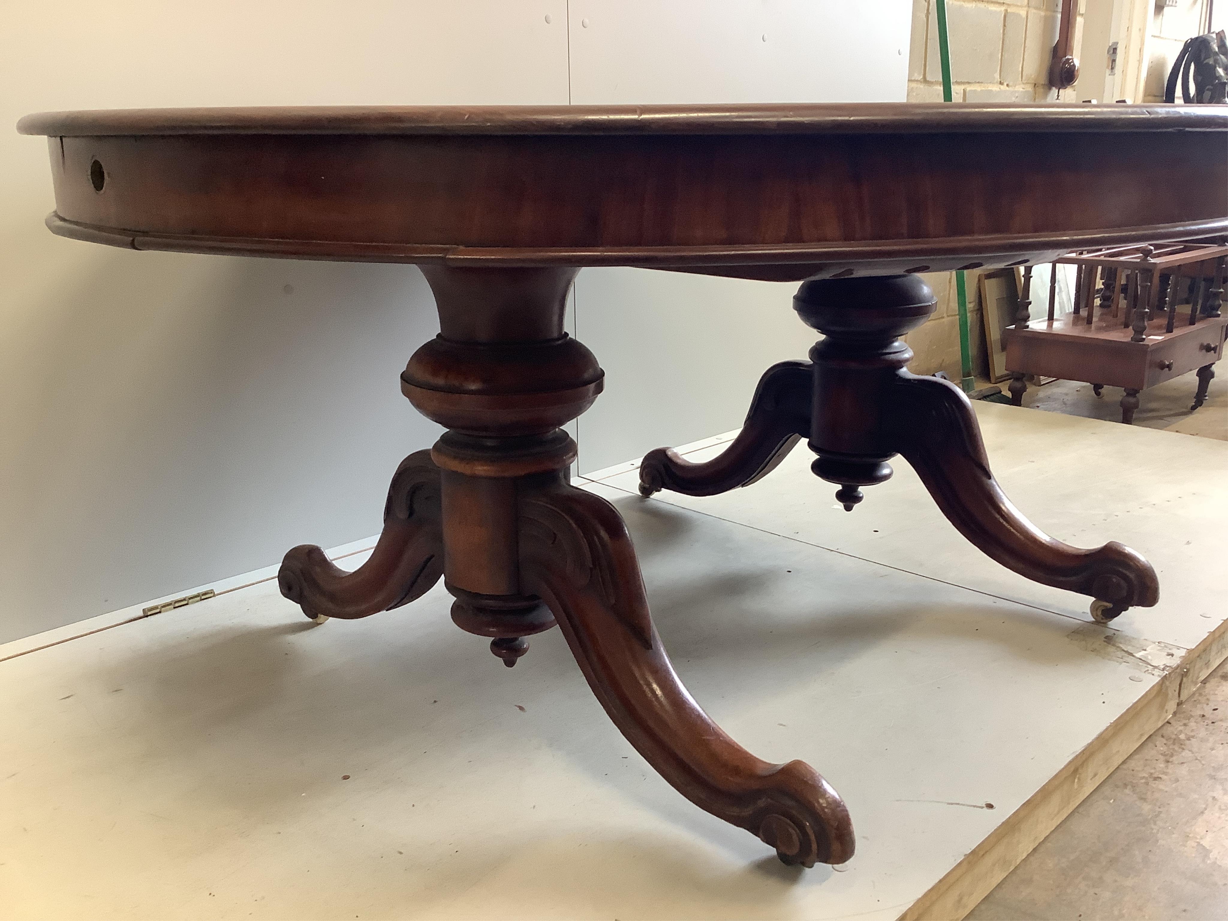 A Victorian mahogany twin pillar extending dining table, 246cm extended, two spare leaves, depth 134cm, height 71cm. Condition - fair